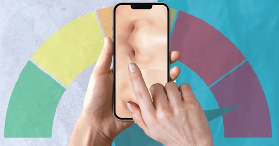 White female hands holding a smartphone showing two white noses with a meter ranging from green to red in the background.